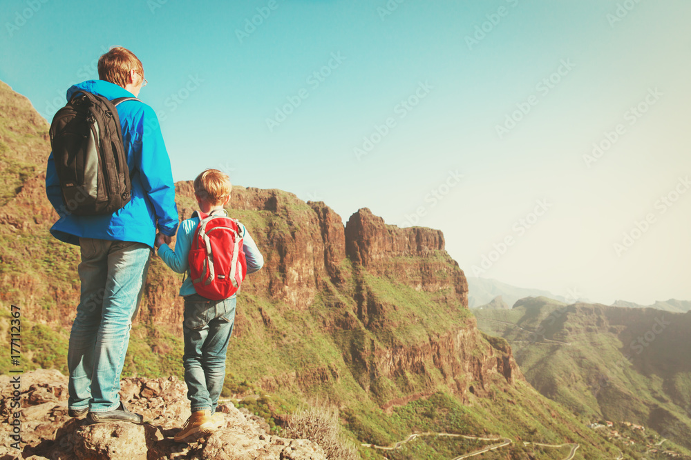 father and son travel hiking in mountains