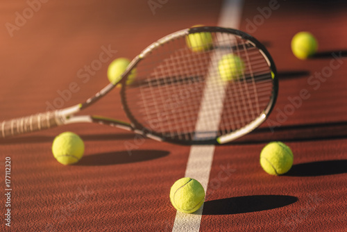 Balls and racket on tennis court © Vasyl