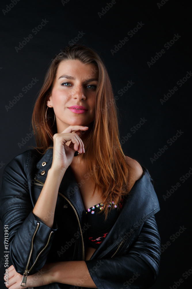 Photo of long-haired woman in lingerie, leather jacket