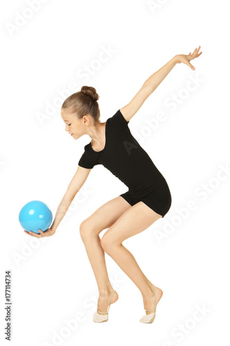 Young girl gymnast with ball on white background