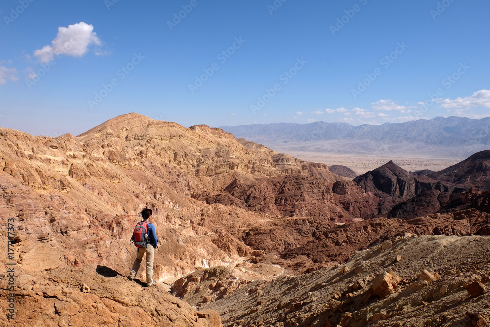 Alone hiker at background of beautiful scenery in Eilat Mountains. Alone hiker at background of beautiful scenery in Eilat Mountains.