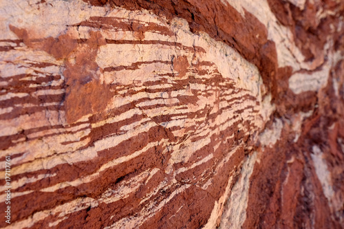 Red sandstone natural background with white stripes.
