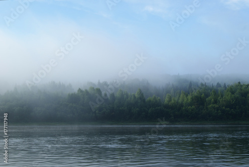 Morning mist over the Ural river Vishera. View across the river to the opposite shore, lost in the fog
