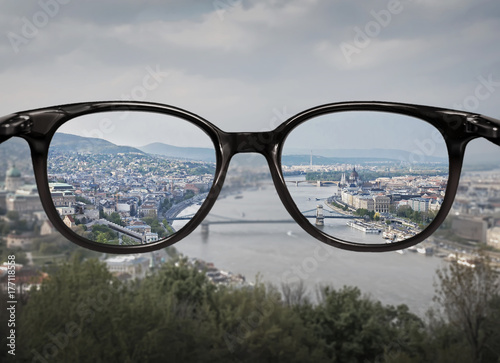 Clear vision through glasses over city landscape