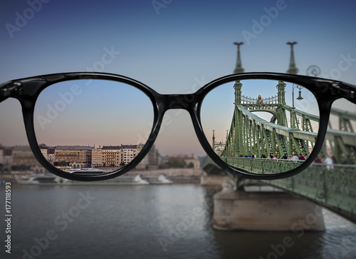 Clear vision through glasses over river bridge landscape
