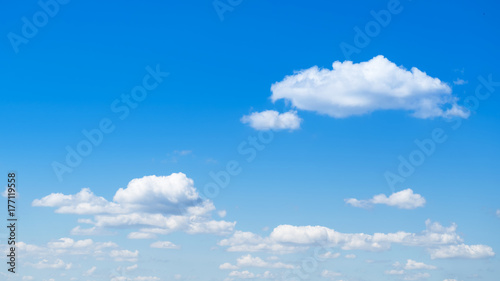 Wide clear blue sky with fluffy clouds