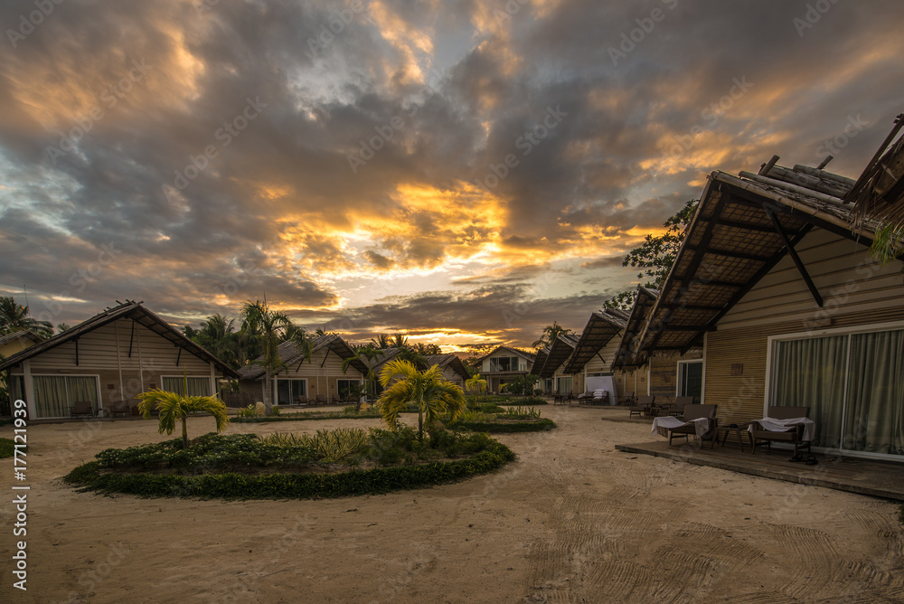 Fototapeta premium Small guest houses over a beautiful sunset. Philippines.