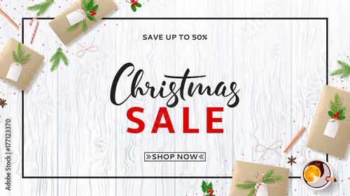 Christmas Sale Web Banner with Festive Composition. Top View on Xmas Decoration with Paper Gift Boxes for Happy New Year. Greeting Card with Lettering. Vector Illustration with Discount Offer.