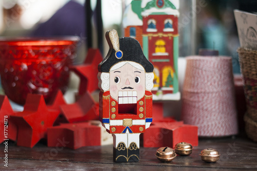 Картината върху платно Nutcracker on a rustic table with christmassy objects