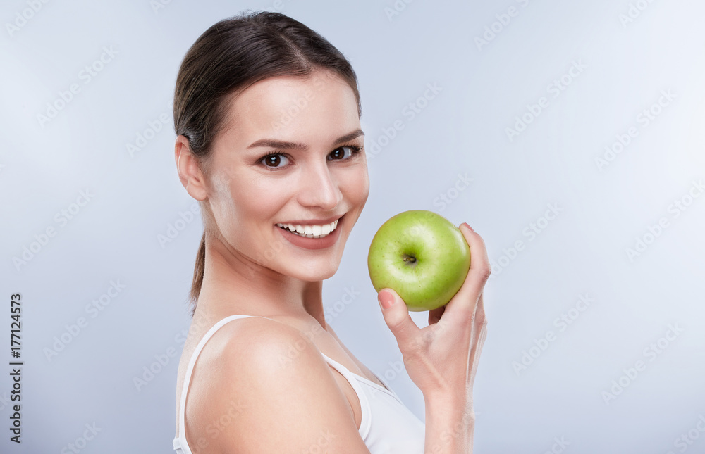 Smiling woman with green apple Smiling woman with green apple