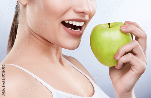 White smile and green apple