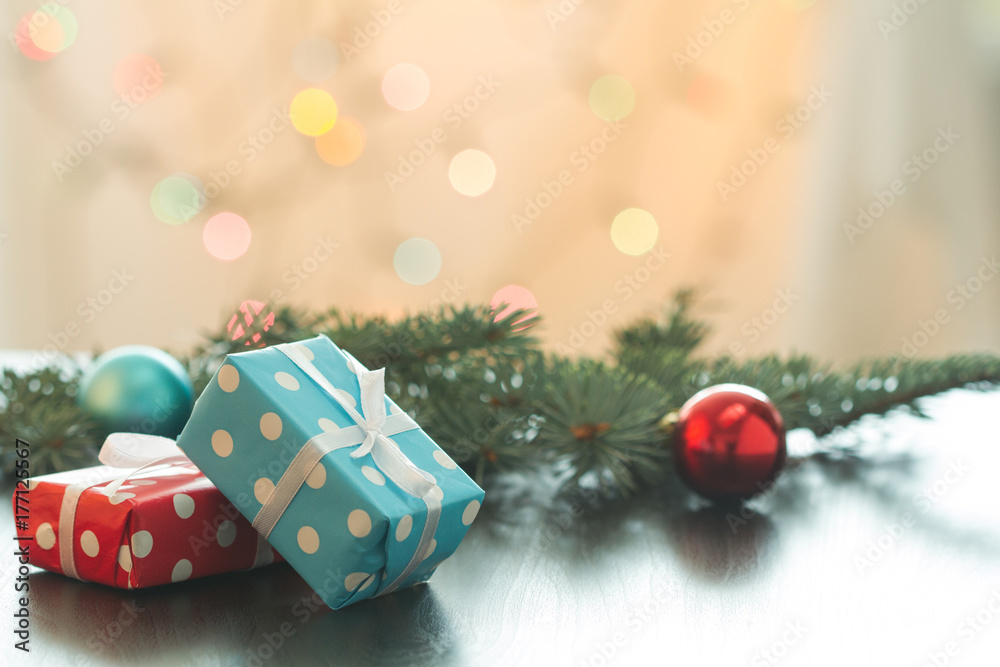 Christmas gifts or New Year with decorations on table on bokeh background