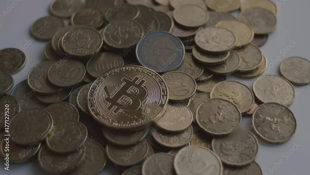 Gold Bitcoin Coin Drop over Euro Coins in Slow Motion Gold Bitcoin Coin Drop over Euro Coins in Slow Motion