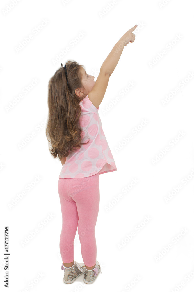 Back view of adorable little girl pointing empty copy space. Rear view. Isolated on white background