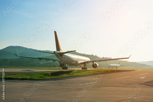 Tableau sur toile Big passenger airplanes on runway strip are taxiing for take-off