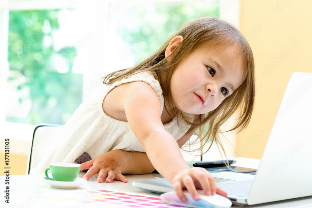 Little girl with her laptop computer at home Little girl with her laptop computer at home