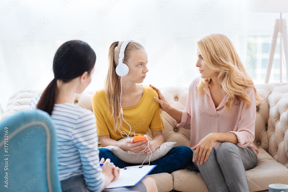 Nice blonde woman holding her daughters shoulder Nice blonde woman holding her daughters shoulder