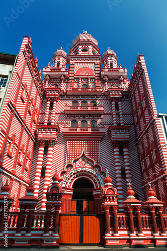 Colombo, Sri Lanka - 11 February, 2017: The decorative red-and-white facade of Jamiul Alfar Mosque in the heart of the bazaar of Pettah, one of the oldest districts in Colombo.