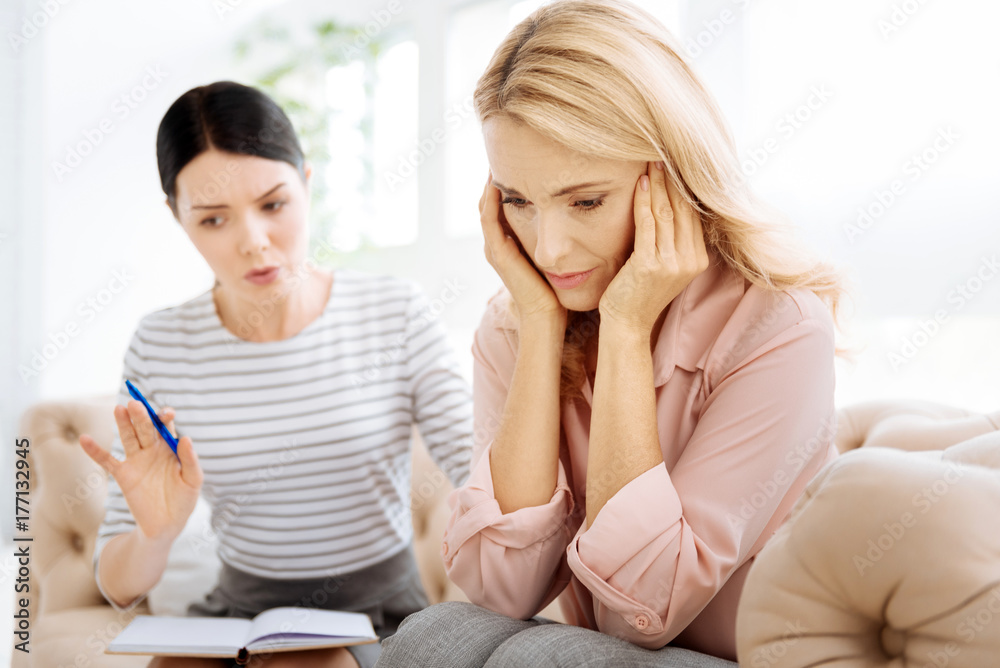 Unhappy blonde woman holding her head Unhappy blonde woman holding her head