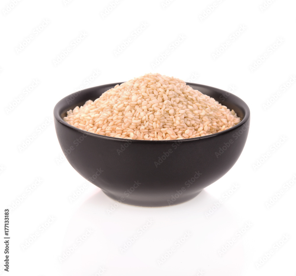 White Sesame Seeds in bowl on white background White Sesame Seeds in bowl on white background