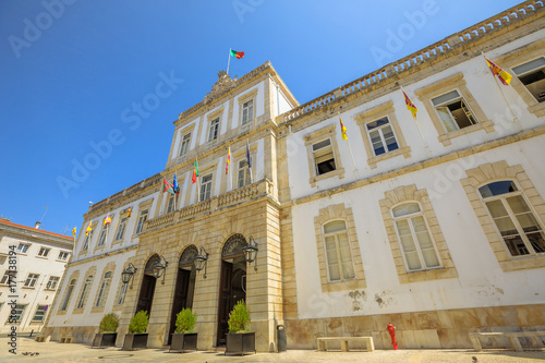 Facade of Town Hall of historic center of Coimbra in Praca 8 de Maio, sunny day with blue sky. Coimbra University Town in Central Portugal, Europe. Bottom view.