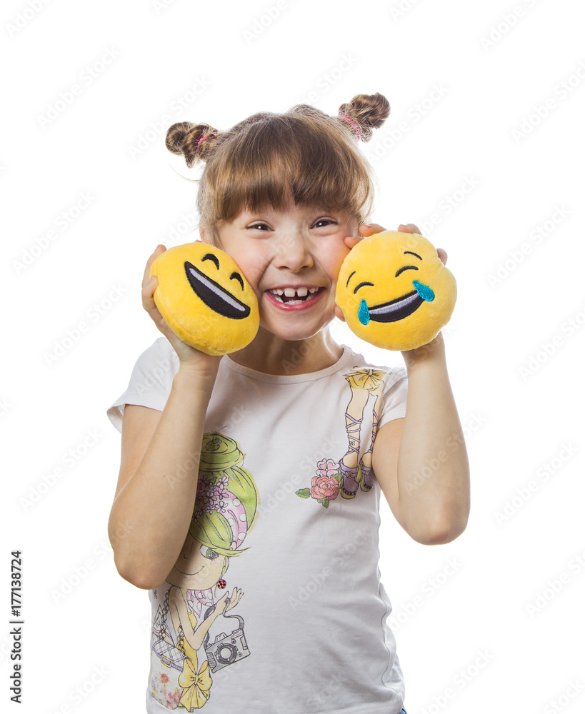A young girl with blond hair is holding toy cheerful smiley. white isolated background A young girl with blond hair is holding toy cheerful smiley. white isolated background