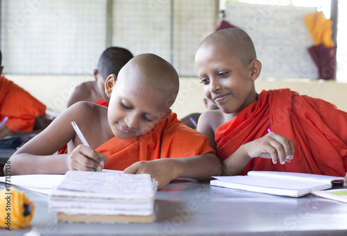 Buddhist monks studying in a classroom photo