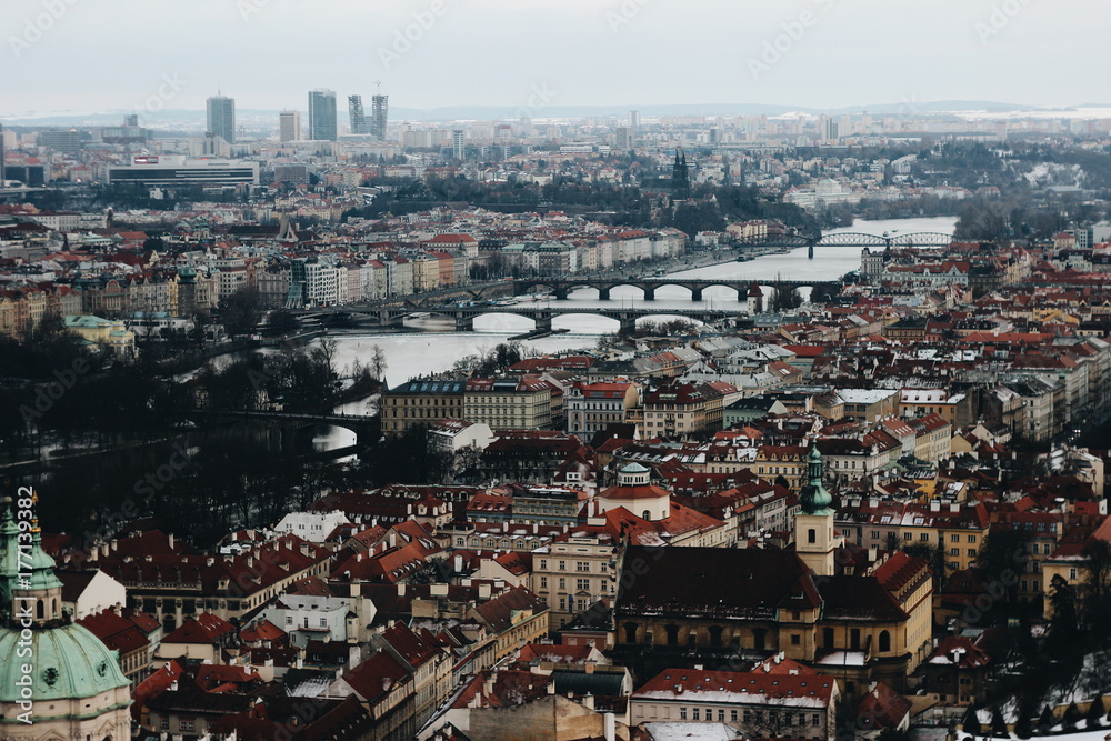Panorama of the city of Prague with houses and a bridge across the river. Nice view on the postcard.