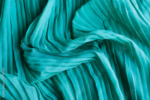 The texture of the mint pleated fabric. Green georgette fabrics. photo