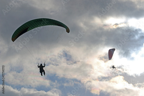 paragliders in silhouette