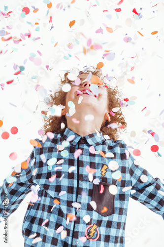 Young boy playing with confetti