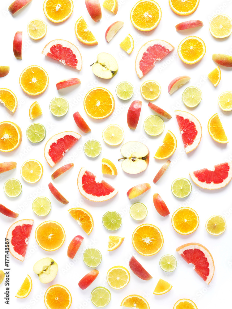 Naklejka Food pattern of fresh fruit in a cut. Oranges, grapefruit, lemons, bananas, apples tangerines slices. Top view, flat lay. Citrus fruits background, wallpaper.