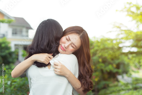 Girl embracing to comfort to her sad best friend after break up