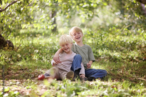Two Happy Children Laughing Outside in the Forest
