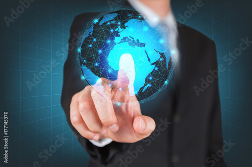 Businessman give a thumbs up for touching the glowing hologram digital globe as business, innovation, intelligent, idea and globalization concept.