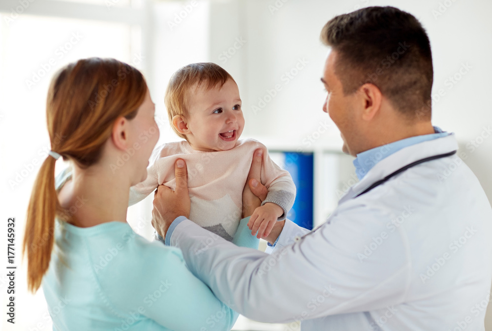 happy woman with baby and doctor at clinic