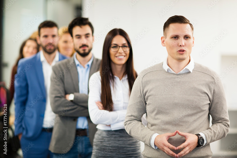Team of cheerful businesspeople posing for group picture Team of cheerful businesspeople posing for group picture