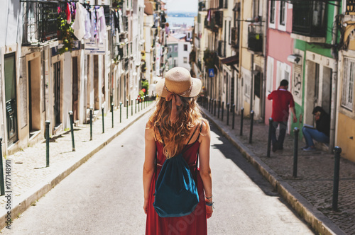 Woman on tour on sothern city streets on summer photo