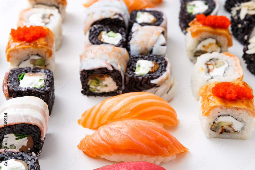 Closeup set of sushi rolls, maki with caviar on white background Closeup set of sushi rolls, maki with caviar on white background