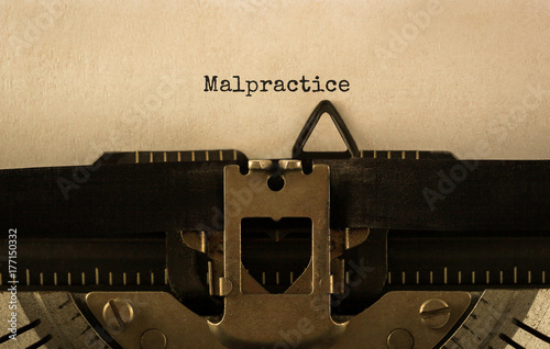 Text Malpractice typed on retro typewriter