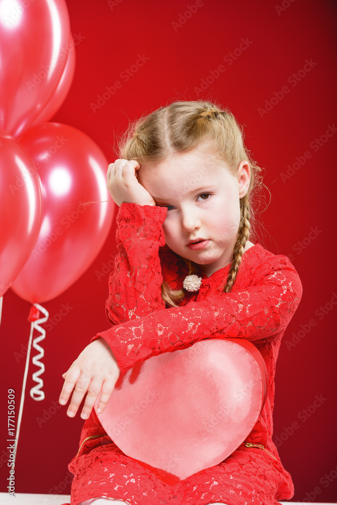 Valentine's Day girl in red dress with a red heart. Valentine's Day girl in red dress with a red heart.