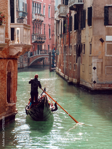 Gondolier floats on the narrow channel in Venice, Italy © Ulia Koltyrina