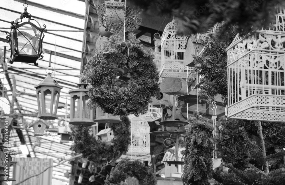 Christmas wreathes at bird market in Paris (France). Black and white.