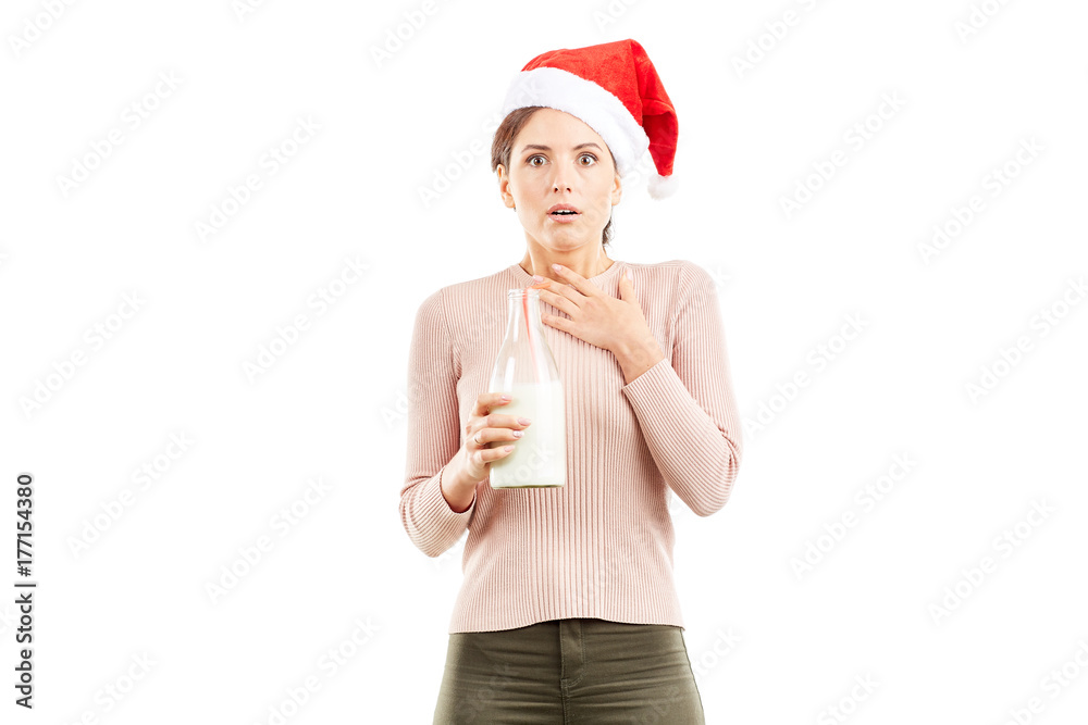 Portrait of woman in Santa hat holding bottle of milk on white background Portrait of woman in Santa hat holding bottle of milk on white background