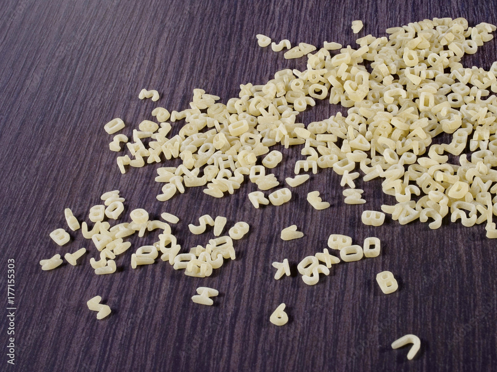 alphabet. raw pasta. letters of the alphabet from flour. dark background alphabet. raw pasta. letters of the alphabet from flour. dark background