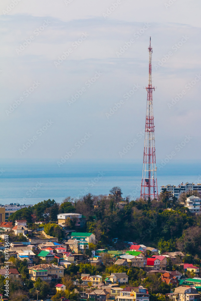 Fototapeta premium Aerial view of buildings an TV tower on the background of the sea in sunny day, Sochi, Russia