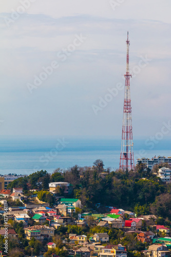 Aerial view of buildings an TV tower on the background of the sea in sunny day  Sochi  Russia