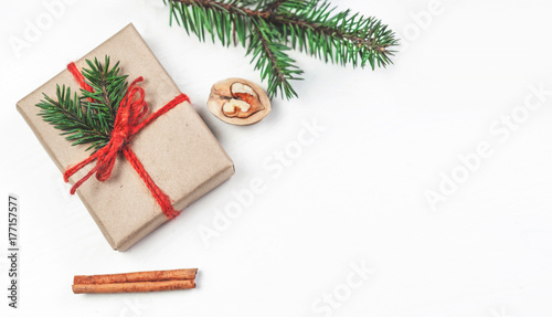 Christmas holidays background with festive decorations and gift boxes on white wooden board. Flat lay, top view.