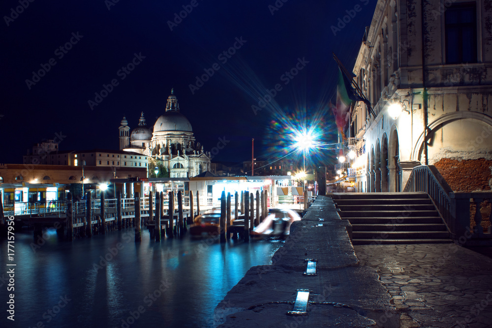 Night view Cathedral of Santa Maria della Salute and gondola in the foreground in Venice, Italy