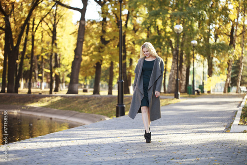 Portrait of a young beautiful woman in gray coat